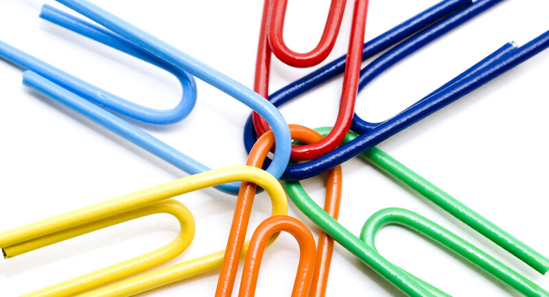 Colorful paperclips linked together at a central nexus