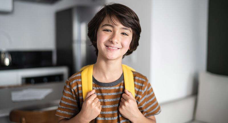 Photo of a middle-school student wearing a yellow backpack